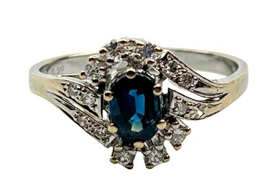 Lot 319 - Sapphire and Diamond Ring.