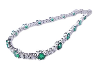 Lot 282 - Emerald and Diamond Tennis Bracelet.