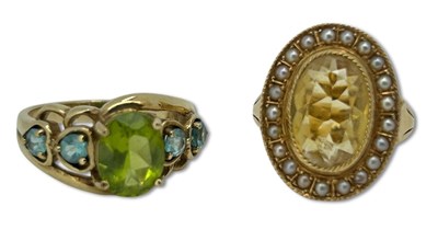 Lot 406 - A Citrine and a Peridot Ring.