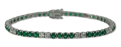 Lot 353 - Diamond and Emerald Tennis Style Bracelet.