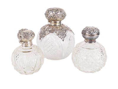 Lot 550 - Three glass Bottles with Silver Fittings.